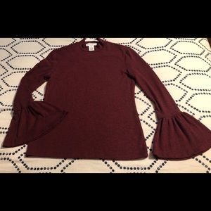 For The Republic high neck, bell sleeve shirt.